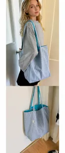 Close-up of blue gingham nylon tote bag featuring durable straps and soft blue lining