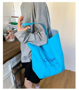 Bright blue nylon tote bag with double-sided grid lining and spacious design on shoulder