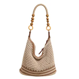 Beige hollow knit tote bag with brown stripes and decorative wooden bead strap