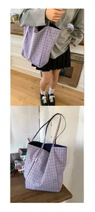 Detailed view of canvas tote bag with light blue checkered pattern and brand label