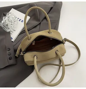 Detailed interior of khaki Boston bag showing lining, inner pocket and zipper closure