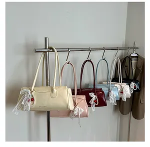 Detail view of stylish small square bags in six colors with lace bows and cherry charms