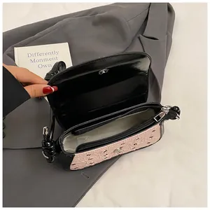 Detailed interior of two-tone crossbody bag showing magnetic closure and zipper pocket