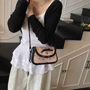Sweet pink crossbody small square bag with black bows and heart charm worn by model