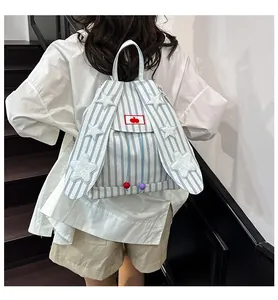 Detail of rabbit ears on blue striped canvas backpack with plush stars and cherry patch