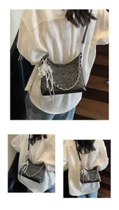 Close-up of glittery tweed crossbody bag with silver star pendant and chain detail