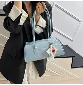 Light blue faux leather handbag with cherry pearl charm accessory for summer fashion