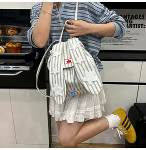 Close-up of striped backpack with plush stars and creative bunny ear design details