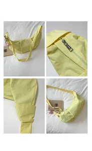Detailsicht der gelben Nylon-Tasche mit Reißverschluss und Herzanhänger-Dekoration