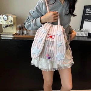 Cute pink striped canvas backpack with rabbit ears and blue stars on a model