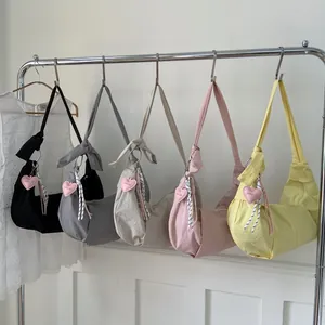 Minimalistische Nylon-Umhängetaschen in fünf Farben mit dekorativen Herzanhängern