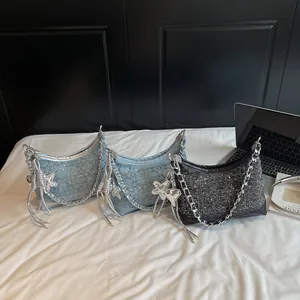 Chic rhinestone studded crossbody bag in denim blue and black with tassel chain detail