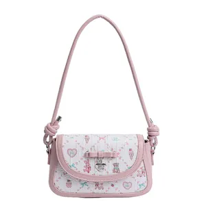 Sweet pink bow shoulder bag with cartoon prints and heart pendant in minimalist white background