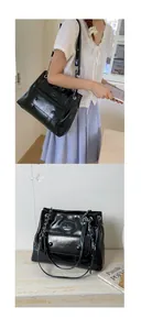 Detail of black faux leather tote bag with silver chain strap and front buckle pocket