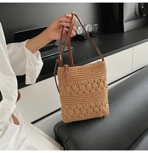 Detail showing the floral crochet texture and adjustable faux leather strap on the woven bag