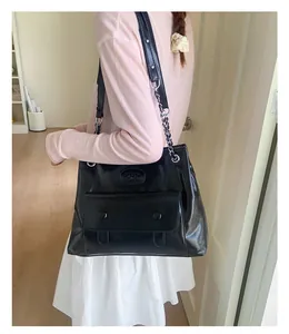 Glossy black faux leather shoulder bag featuring silver chain straps and front flap pocket