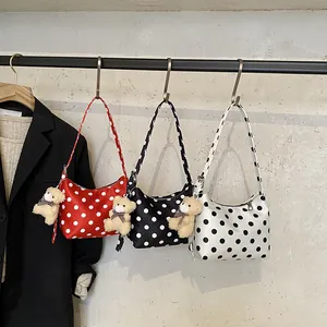Polka dot canvas shoulder bags in red, black, and white with plush bear charms