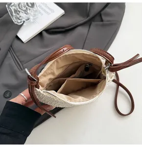 Detail view of woven crossbody bag interior with zip pocket and leather trim
