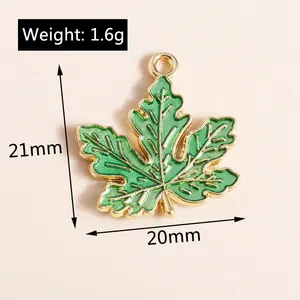 Detail view of 21x20mm green enamel maple leaf pendant with golden metal edges