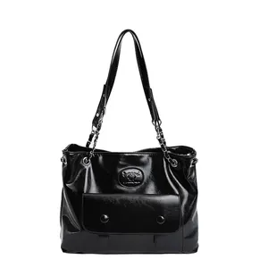Chic black glossy shoulder bag with vintage buckle detail and chain strap for women