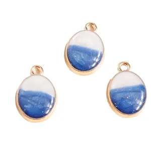 Three teardrop star-themed pendants with gold alloy frames and navy blue resin glitter
