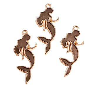 Three mermaid pendants in gold finish with dark brown glitter enamel for DIY jewelry making