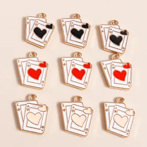 Macro view of poker card heart and spade pendants with gold-plated edges for DIY jewelry