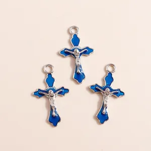 Dettaglio di ciondoli a croce in smalto blu con rilievo di Gesù in argento