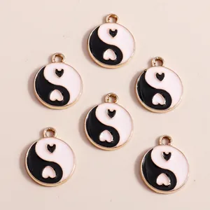 Detailed view of Chinese Yin Yang heart pendants with gold plating and enamel finish