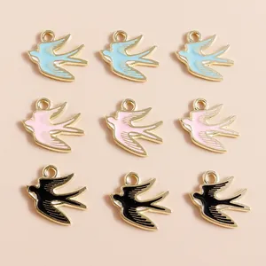 Macro shot of 9 colorful enamel swallow bird charms with gold plating for jewelry DIY