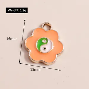Macro shot of a floral Tai Chi pendant showing dimensions 16mm x 15mm and 1.2g weight