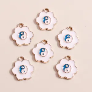 Detailed view of six flower-shaped Tai Chi enamel charms with gold alloy edges for DIY jewelry