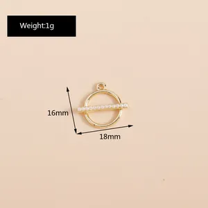 Detail of a 18mm golden geometric round pendant with white faux pearls for DIY jewelry