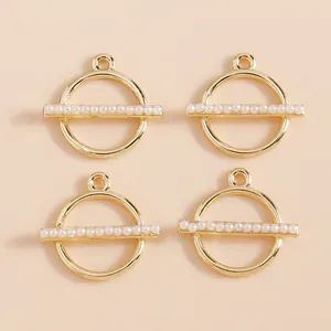 Detailed macro view of four minimalist gold geometric round pendants with white pearls