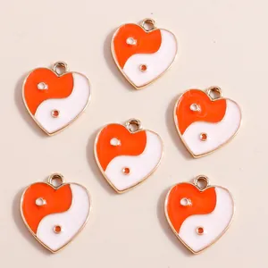 Set of heart-shaped pendants featuring orange and white Yin Yang Tai Chi enamel designs