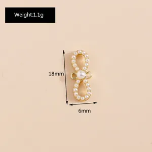 Detailed view of infinity bow pendant with cat eye stones and 18mm size measurements