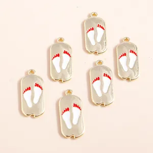 Golden alloy dog paw print pendants with white and red enamel finish for DIY jewelry