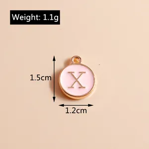 Detailed view of pink enamel alphabet X charm with gold trim and size measurements
