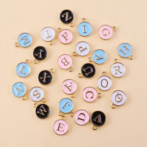 Macro view of colorful enamel alphabet charms with gold plating for DIY jewelry making