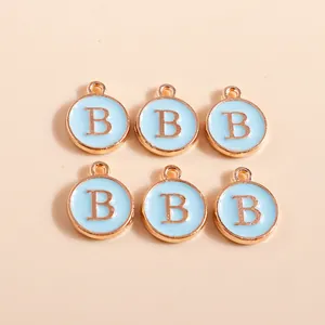 DIY letter B charms in gold alloy with blue enamel finish and hanging loops for jewelry