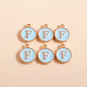 Macro view of blue enamel gold-tone letter F charms for jewelry making and DIY crafts