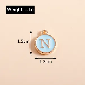 Detail of light blue enamel letter N charm with gold plating for DIY jewelry making