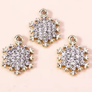 Three gold snowflake pendants with inlaid rhinestones for DIY jewelry making and crafts