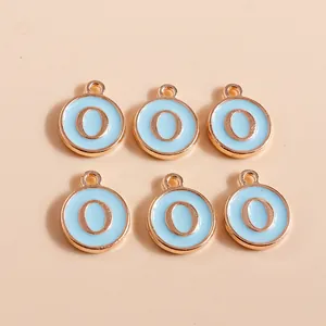 Close-up of sky blue enamel letter O charms with golden alloy plating for DIY crafts