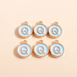 Detail of round light blue enamel letter Q charms with rose gold plated finish