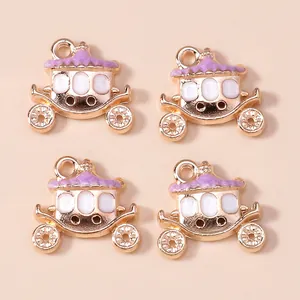Detailed macro view of four gold-plated lavender enamel pumpkin carriage charms