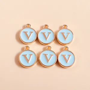 Macro shot of 6 light blue enamel and rose gold initial V charm pendants for DIY jewelry