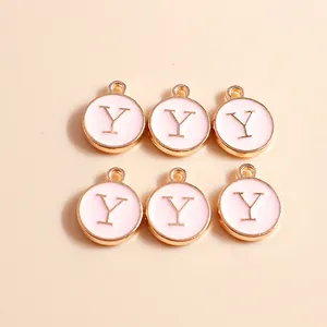 Close-up of pink enamel letter Y charms with golden metal edges for jewelry DIY