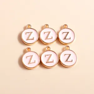 Macro shot of 6 pink enamel letter Z charms with gold borders for DIY jewelry making
