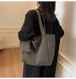 Detail of grey-green houndstooth tote bag with mini zipper pouch and olive canvas strap